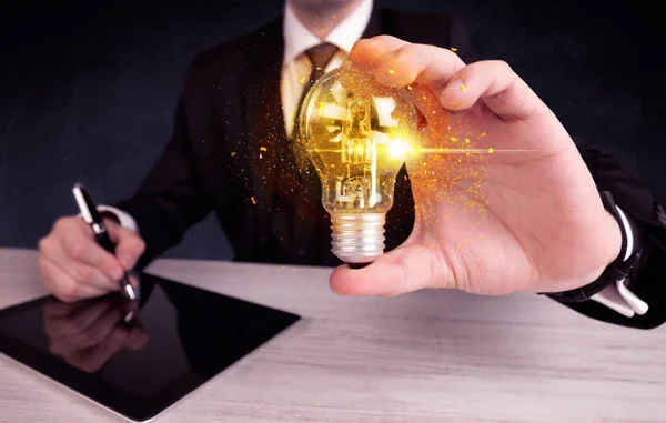 Office worker holding a light bulb — Stock Photo, Image