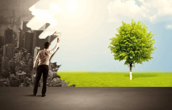 Salesman painting tree instead of city — Stock Photo, Image