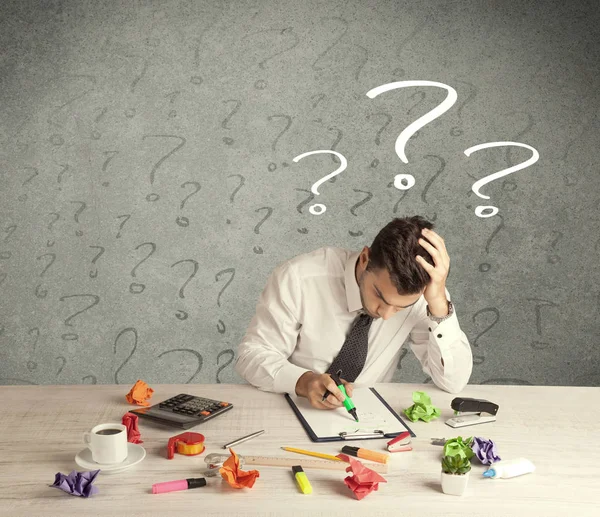 Businessman at desk with question mark — Stock Photo, Image