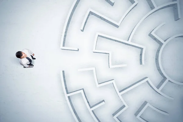 Business man looking at circular maze with nowhere to go — Stock Photo, Image