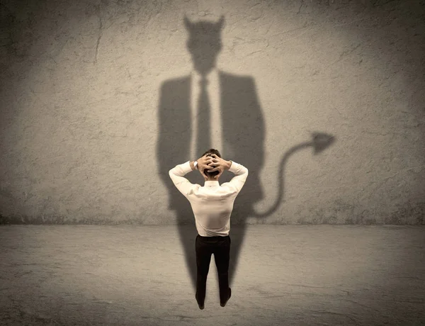 Salesman facing his own devil shadow — Stock Photo, Image