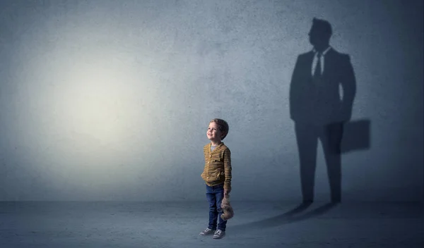 Little boy with businessman shadow Royalty Free Stock Photos