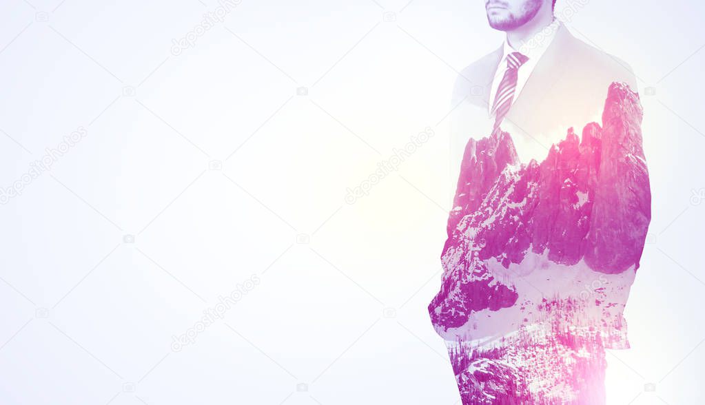 Businessman standing with mountain graphic