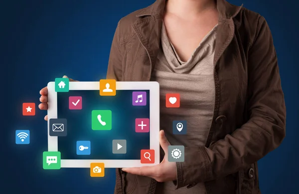 Woman holding tablet with multimedia graphics — Stock Photo, Image