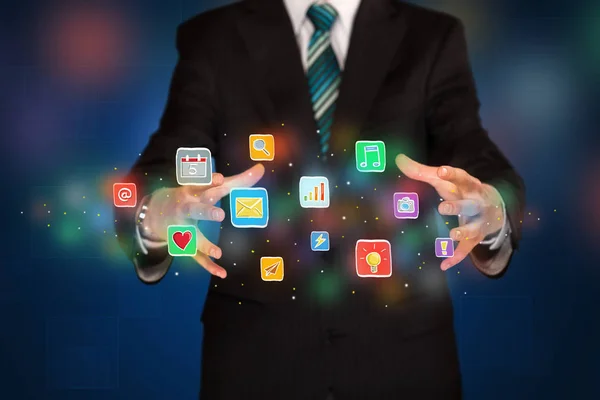 Businessman holding application icons — Stock Photo, Image