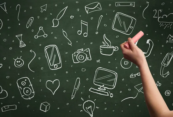 Hand writing icons on blackboard — Stock Photo, Image