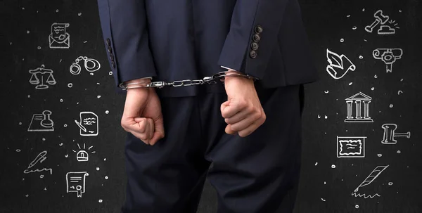 Symbols of courthouse with handcuffed man — Stock Photo, Image