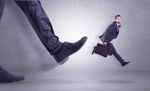 Foot kicking, businessman flying — Stock Photo, Image