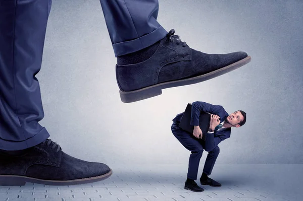 Young businessman getting crushed — Stock Photo, Image