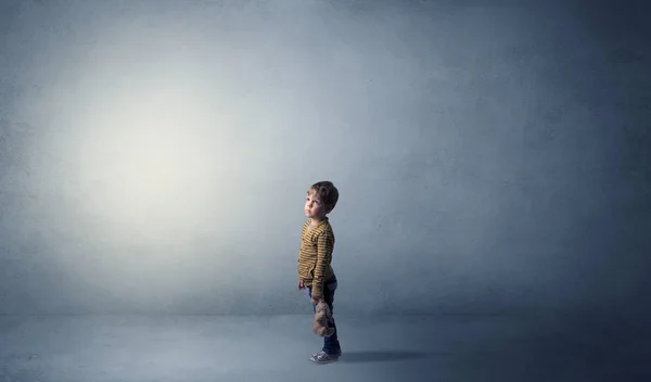 Little waggish kid in an empty room — Stock Photo, Image