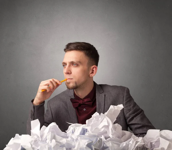 Businessman behind crumpled paper