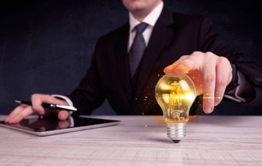 bir ampul tutarak ofis çalışanı