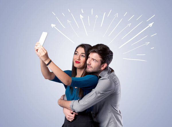 Cute couple taking selfie with arrows