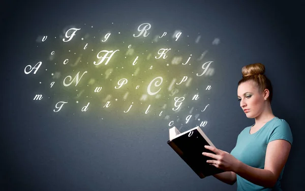 Young lady holding book with letters — Stock Photo, Image