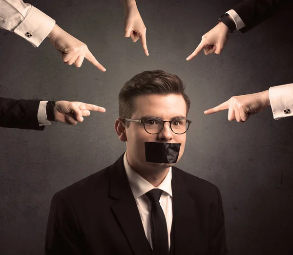 Multiple hands pointing at business employee — Stock Photo, Image