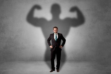 Businessman with muscular shade behind his back clipart