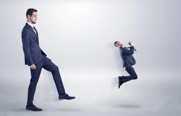 Small man fired by boss with white wallpaper — Stock Photo, Image