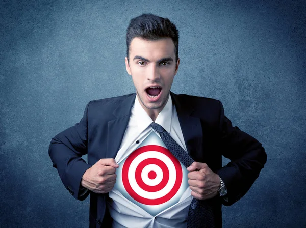 Businessman tearing shirt with target sign on his chest — Stock Photo, Image