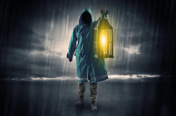 Man walking in storm with lantern