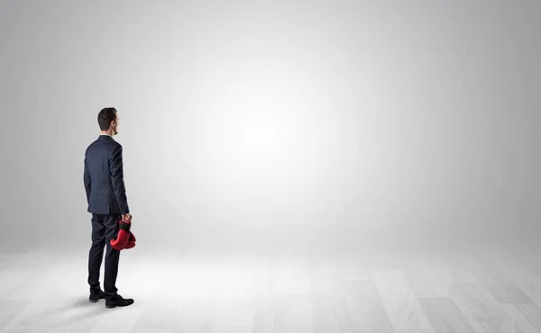 Man with object in his hand in an empty space — Stock Photo, Image