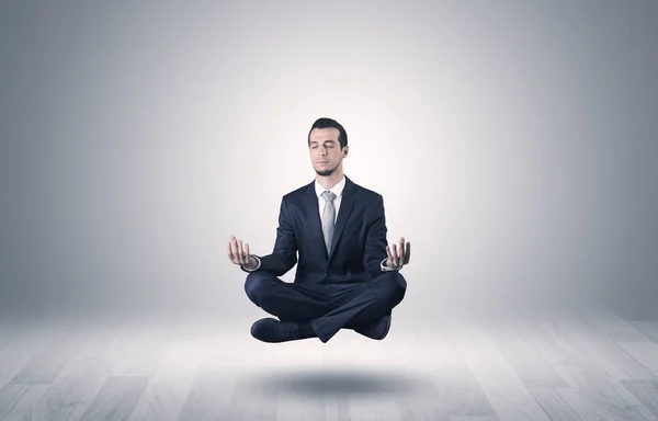 Businessman meditates in an empty space concept — Stock Photo, Image