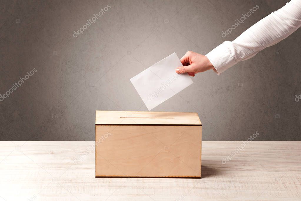 Ballot box with person casting vote 