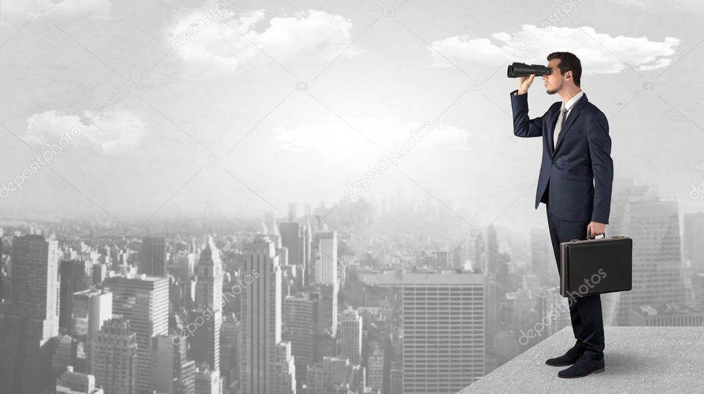 Man looking forward from the top of a skyscraper