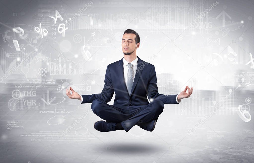 Businessman meditates with enlightenment concept