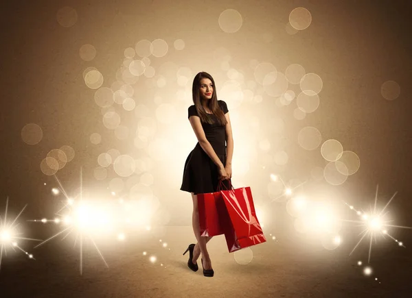 Compras señora con bolsas en luces brillantes —  Fotos de Stock