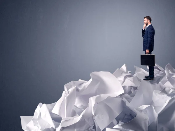 Businessman standing on crumpled paper — Stock Photo, Image