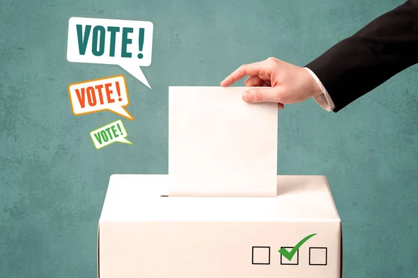 Placing a voting slip into a ballot box — Stock Photo, Image