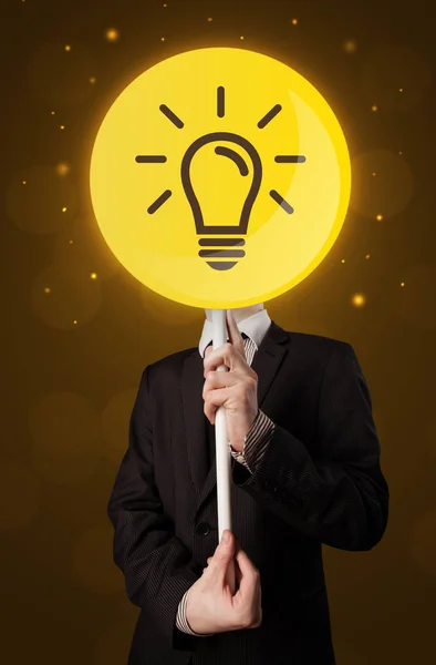 Podnikatel, drží žárovku znamení — Stock fotografie