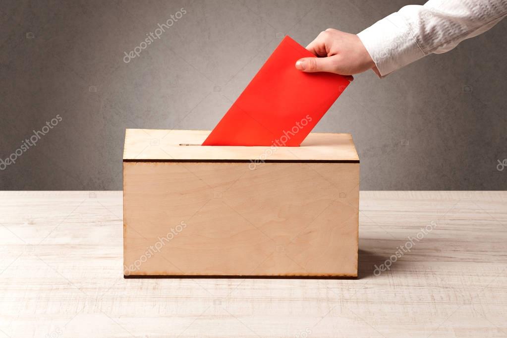 Ballot box with person casting vote 