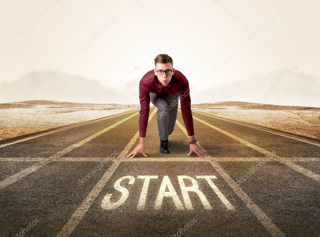 Businessman kneeling in ready position