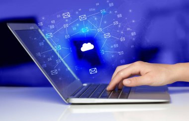 Hand using laptop with centralized cloud computing system concep clipart