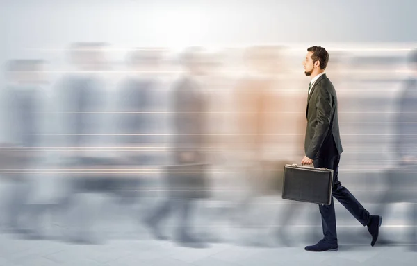 Businessman walking on a crowded street — Stock Photo, Image