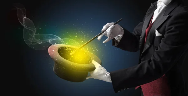 Illusionist hand making trick with wand — Stock Photo, Image