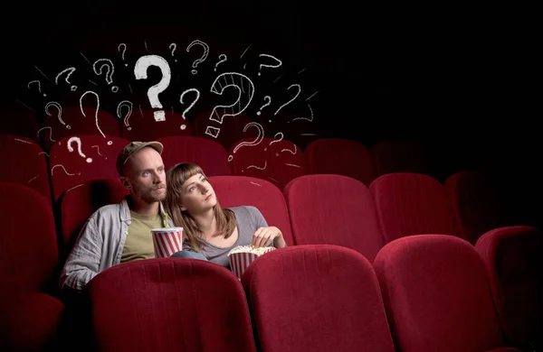 Couple in cinema with questions — Stock Photo, Image