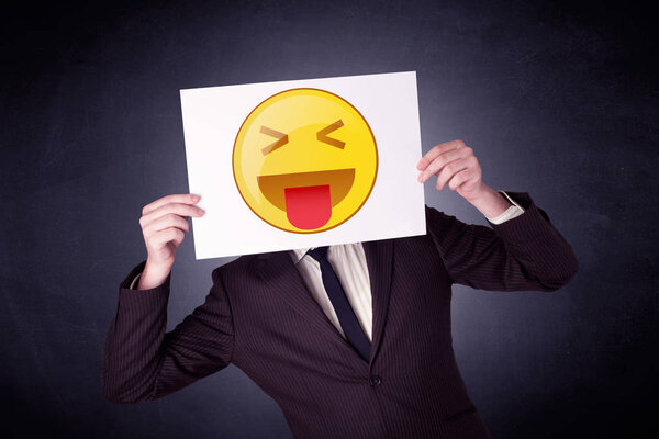 Businessman holding paper with emoticon 