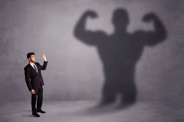 Business man looking at his own strong fit shadow concept — Stock Photo, Image