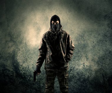 Portrait of a heavily armed masked soldier with grungy backgroun clipart