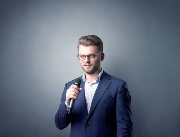 Businessman holding microphone — Stock Photo, Image