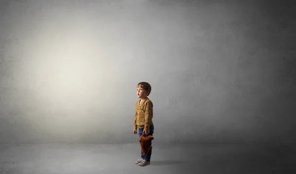 Little waggish kid in an empty room — Stock Photo, Image