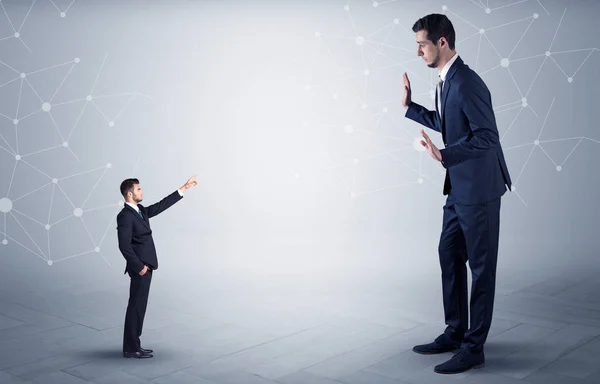 Small man aiming at a big man with network concept — Stock Photo, Image