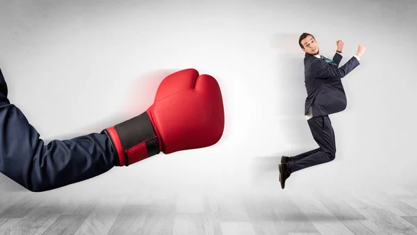 Luva de boxe vermelho derruba pequeno homem de negócios — Fotografia de Stock