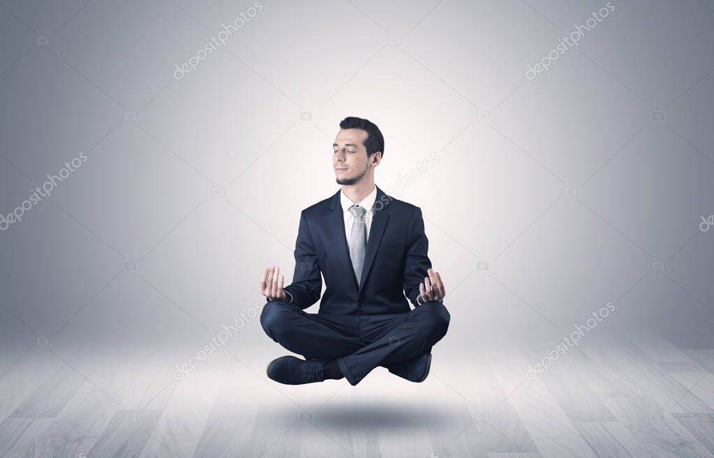 Businessman meditates in an empty space concept