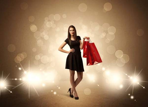 Compras señora con bolsas en luces brillantes —  Fotos de Stock