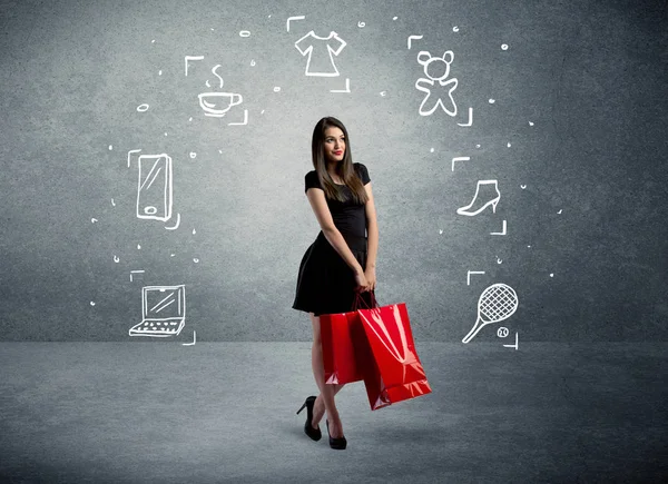 Shopping-Weibchen mit Taschen und gezeichneten Symbolen — Stockfoto