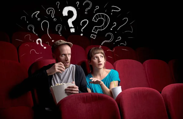 Couple in cinema with questions