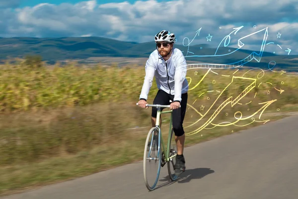 Young cyclist in with meadow background — Stock Photo, Image